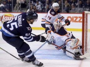 Jets’ Mark Scheifele scores on Oilers’ goaltender Mikko Koskinen during second period Sunday night.