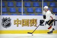 Sam Bennett of the Calgary Flames skates with the puck during a team practice in Beijing, China, Monday, Sept. 17, 2018. The Flames faced off against the Boston Bruins in southern Chinese city of Shenzhen on Saturday and will play the Bruins again in Beijing on Wednesday in the 2018 NHL China Games. The sign reads "China Games". (AP Photo/Mark Schiefelbein) ORG XMIT: XMAS114