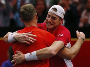 Team World's John Isner, right, and Jack Sock celebrate their win over Team Europe's Roger Federer and Alexander Zverev in a men's doubles tennis match at the Laver Cup, Sunday, Sept. 23, 2018, in Chicago.