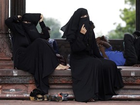 In this  Aug. 22, 2017 file photo, Indian Muslim women rest inside Jama Masjid mosque in New Delhi, India.