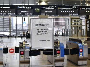 A notice informing cancelled trains is placed at the gates of Osaka Station in Osaka, western Japan, Tuesday, Sept. 4, 2018.