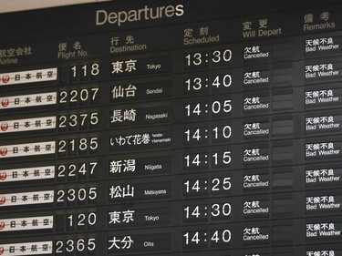 A flight information board shows the cancellation of flights at Osaka airport, western Japan, Tuesday, Sept. 4, 2018.