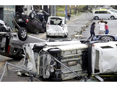 Overturned cars are seen on street following a powerful typhoon in Osaka, western Japan, Tuesday, Sept. 4, 2018.