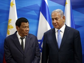 Israeli Prime Minister Benjamin Netanyahu, right, stands next to Philippine President Rodrigo Duterte during their meeting in Jerusalem on Monday, Sept. 3, 2018.
