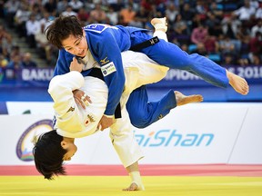 Canada's Christa Deguchi (blue) fights with Japan's Tsukasa Yoshida during the Women under 57 kg category bout as part of the 2018 Judo World Championships in Baku on Sept. 22, 2018.