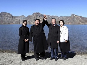 South Korean President Moon Jae-in, second from right, and his wife Kim Jung-sook, right, stand with North Korean leader Kim Jong Un, second from left, and his wife Ri Sol Ju on the Mount Paektu in North Korea, Thursday, Sept. 20, 2018.