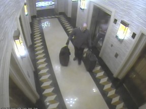 In this Sept. 27, 2017, security camera image released by MGM Resorts, Stephen Paddock stands with luggage by elevators at the Mandalay Bay hotel in Las Vegas. The newly released video shows the man who killed 58 people on the Las Vegas Strip moving around a casino before the attack, gambling, bringing suitcases into his room at Mandalay Bay but doing nothing that would obviously raise suspicions. (MGM Resorts via AP) ORG XMIT: FX107