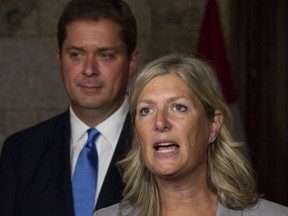 Leader of the Opposition Andrew Scheer looks on as MP Leona Alleslev, who crossed the floor from the Liberal party to Conservative party before Question Period, speaks with the media in the Foyer of the House of Commons on Parliament Hill in Ottawa, Monday Sept. 17, 2018.
