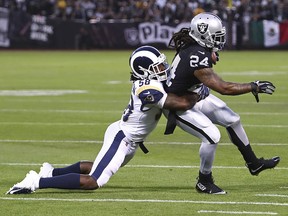Oakland Raiders running back Marshawn Lynch is tackled by Los Angeles Rams linebacker Cory Littleton (58) in Oakland, Calif., Monday, Sept. 10, 2018. (AP Photo/Ben Margot)