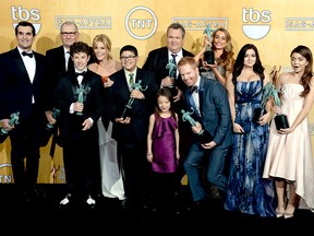 In this Jan. 18, 2014, file photo, the cast of "Modern Family," winner of the Best Ensemble in a Comedy Series award, poses in the press room at the 20th annual Screen Actors Guild Awards at the Shrine Auditorium  in Los Angeles.