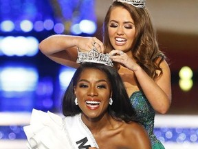 Miss New York Nia Franklin reacts after being named Miss America 2019, as she is crowned by last year's winner Cara Mund, Sunday, Sept. 9, 2018, in Atlantic City, N.J.