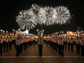 North Korean youths holding torches march during the torch light march at the Kim Il Sung Square in conjunction with the 70th anniversary of North Korea's founding day in Pyongyang, North Korea, Monday, Sept. 10, 2018.