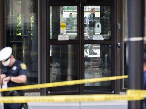 Police investigate the scene after a shooting at the Fifth Third Bank building on Fountain Square, Thursday, Sept. 6, 2018, in downtown Cincinnati.