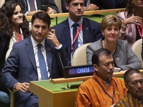 Canadian Prime Minister Justin Trudeau and International Development Minister Marie-Claude Bibeau listen to speakers at the Nelson Mandela Peace Summit opening ceremony at the United Nations Headquarters, Monday, Sept. 24, 2018.