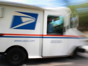 U.S. Postal Service mail carrier, Alberto Jo, delivers mail to homes on August 5, 2010 in Miami, Florida. (Joe Raedle/Getty Images)