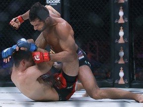 Gegard Mousasi, top, punches Rory MacDonald during a middleweight world title mixed martial arts bout at Bellator 206 in San Jose, Calif., Saturday, Sept. 29, 2018. (AP Photo/Jeff Chiu)