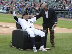Detroit Tigers designated hitter Victor Martinez is presented a chair by Al Avila, executive vice president of baseball operations and general manager, before the Tigers' baseball game against the Kansas City Royals, Saturday, Sept. 22, 2018, in Detroit.