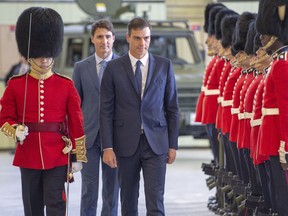 Prime Minister of Spain Pedro Sanchez and Canadian Prime Minister Justin Trudeau inspect the honour guard at the Royal Canadian Hussars Armoury Sunday, Sept. 23, 2018 in Montreal.