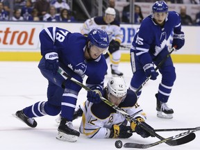 Maple Leafs defenceman Rasmus Sandin checks Buffalo Sabres centre Kevin Porter to the ice during the second period in Fridays pre-season game. JACK BOLAND/TORONTO SUN