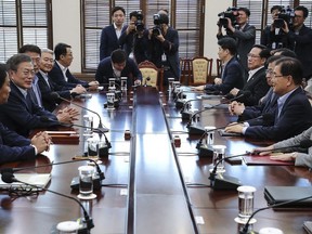 South Korean President Moon Jae-in, second from left, presides over a meeting with his security ministers, including National Security Advisor Chung Eui-yong, second from right, and National Intelligence Service Director Suh Hoon, third from right, one day before Chung and Suh make a one-day trip to North Korea at the presidential Blue House in Seoul, South Korea, Tuesday, Sept. 4, 2018.