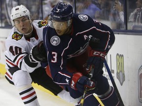 Blue Jackets defenceman Seth Jones, right, tries to clear the puck as Blackhawks' John Hayden defends during third period preseason action in Columbus, Ohio, Tuesday, Sept. 18, 2018.