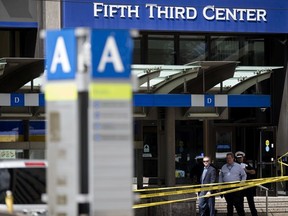 In this Sept. 6, 2018 file photo, police investigate outside Fifth Third Bank building on Fountain Square after a shooting with multiple fatalities in downtown Cincinnati.