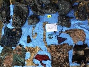 In this undated photo provided by the Veracruz State Prosecutor's Office shows clothing items found at the site of a clandestine burial pit in the Gulf coast state of Veracruz, Mexico.  (Veracruz State Prosecutor's Office via AP)