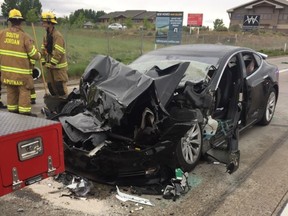 In this May 11, 2018, file photo, released by the South Jordan Police Department shows a traffic collision involving a Tesla Model S sedan with a fire department mechanic truck stopped at a red light in South Jordan, Utah. (South Jordan Police Department via AP, File)