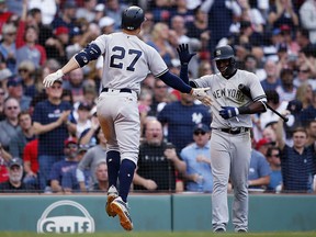 New York Yankees slugger Giancarlo Stanton (27) celebrates his home run with Adeiny Hechavarria during a game against the Boston Red Sox in Boston, Saturday, Sept. 29, 2018. (AP Photo/Michael Dwyer)