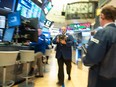 Traders work on the floor at the opening bell of the Dow Industrial Average at the New York Stock Exchange on Aug. 22, 2018 in New York.