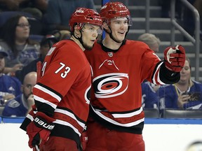 In this Tuesday, Sept. 18, 2018, file photo, Carolina Hurricanes right wing Andrei Svechnikov, right, celebrates his goal against the Tampa Bay Lightning with left wing Valentin Zykov in Tampa, Fla. (AP Photo/Chris O'Meara, File)