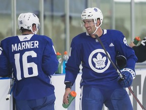 Toronto Maple Leafs' Mitch Marner (left) and John Tavares chat between drills during practice on the opening day of Leafs training camp in Niagara Falls, Ont., Friday, September 14, 2018. (THE CANADIAN PRESS)