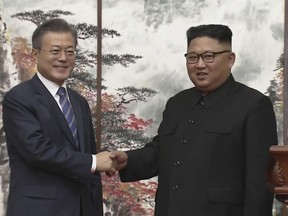 In this image made from video provided by Korea Broadcasting System (KBS),  North Korean leader Kim Jong Un, right, and South Korean President Moon Jae-in shake hands at the end of their joint press conference in Pyongyang, North Korea Wednesday, Sept. 19, 2018. (Korea Broadcasting System via AP)