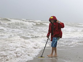 Local resident Mike Squillace looking for metal at Dania Beach, Fla., as Tropical Storm Gordon passes by South Florida with wind gust and heavy rainfall for the Labour Day holiday on Monday, Sept. 3, 2018.