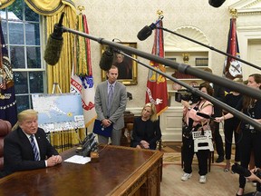 President Donald Trump, left, joined by FEMA Administrator Brock Long, second from left, and Homeland Security Secretary Kirstjen Nielsen, centre, speaks during a briefing on Hurricane Florence in the Oval Office of the White House in Washington, Tuesday, Sept. 11, 2018. (AP Photo/Susan Walsh)