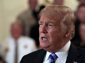 President Donald Trump responds to a reporters question during an event with sheriffs in the East Room of the White House in Washington, Wednesday, Sept. 5, 2018.