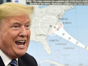 President Donald Trump talks about Hurricane Florence following a briefing in the Oval Office of the White House in Washington, Tuesday, Sept. 11, 2018.