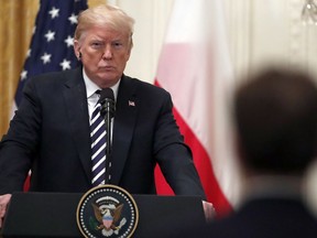 President Donald Trump listens to a reporter's question during a news conference with Polish President Andrzej Duda, in the East Room of the White House, Tuesday, Sept. 18, 2018, in Washington.