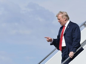 U.S. President Donald Trump walks down the steps of Air Force One at Hector International Airport in Fargo, N.D., Friday, Sept. 7, 2018.