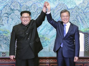 In this April, 27, 2018, file photo, North Korean leader Kim Jong Un, left, and South Korean President Moon Jae-in raise their hands after signing a joint statement at the border village of Panmunjom in the Demilitarized Zone, South Korea. (Korea Summit Press Pool via AP, File)