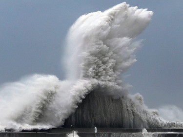 High waves hit breakwaters at a port of Aki, Kochi prefecture, Japan, Tuesday, Sept. 4, 2018.