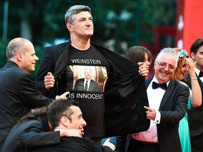 Luciano Silighini flashes a jersey reading "Weinstein is innocent" as guests arrive for the premiere of the film "Suspiria" presented in competition on Sept. 1, 2018 during the 75th Venice Film Festival at Venice Lido.