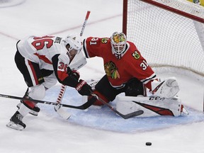 Senators' Colin White skates in on Blackhawks goaltender Anton Forsberg during the first period of Thursday's pre-season game in Chicago. (AP PHOTO)