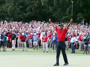 Tiger Woods of the United States celebrates making a par on the 18th green to win the Tour Championship at East Lake Golf Club on Sept. 23, 2018 in Atlanta, Ga.