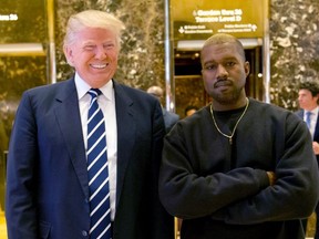 In this Dec. 13, 2016, file photo, then-President-elect Donald Trump and Kanye West pose for a picture in the lobby of Trump Tower in New York.