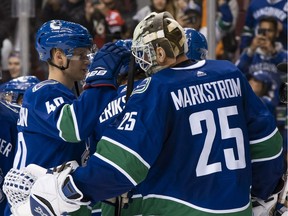 Rookie Elias Petterson congratulates Vancouver goalie Jacob Markstrom on Wednesday after the Canucks beat the Calgary Flames 5-2 at Rogers Arena.