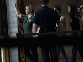 Comedian Amy Schumer is led away after she was arrested during a protest against the confirmation of Supreme Court nominee Judge Brett Kavanaugh October 4, 2018 at the Hart Senate Office Building on Capitol Hill in Washington, DC. Senators had an opportunity to review a new FBI background investigation into accusations of sexual assault against Kavanaugh and Republican leaders are moving to have a vote on his confirmation this weekend.