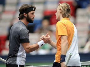 Nikoloz Basilashvili of Georgia (L) shakes hands after victory in his match against Denis Shapovalov of Canada during First Round in 2018 Rolex Shanghai Masters on Day 3 at Qi Zhong Tennis Centre on October 9, 2018 in Shanghai, China.