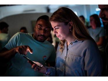 A member of Google staff shows the the new Google Pixel 3 to a guest at a Google hardware launch event at The Yard on Oct.  9, 2018 in London, England.
