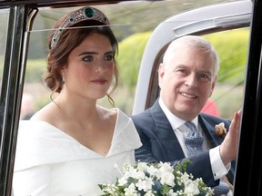 The bride Princess Eugenie of York with her father Prince Andrew, Duke of York arrives by car for her Royal wedding to Mr. Jack Brooksbank at St. George's Chapel on October 12, 2018 in Windsor, England.